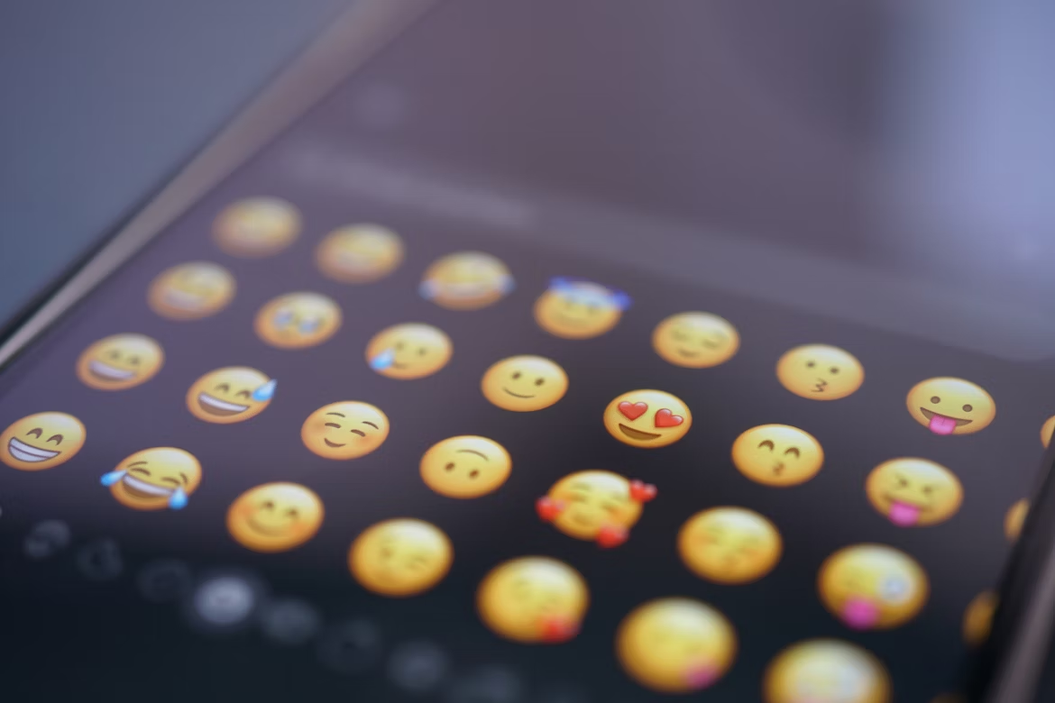 Smartphone emoji keyboard showing a collection of smileys and symbols.