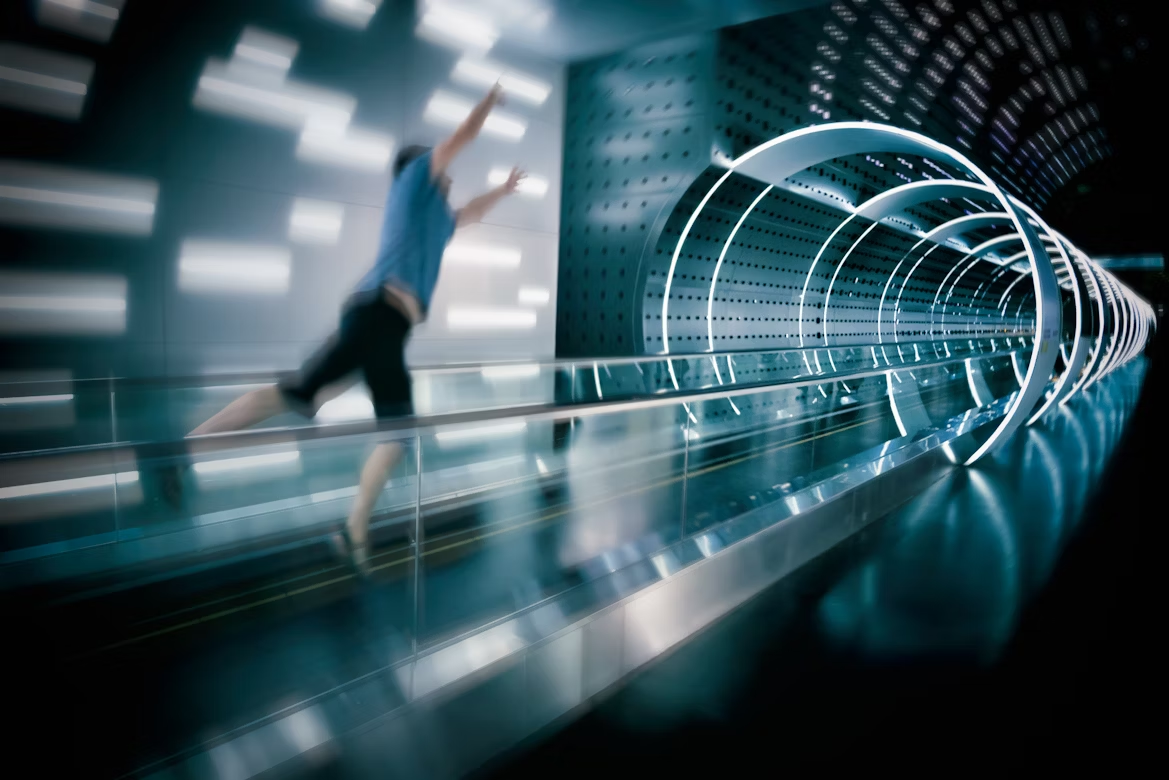 Blurred person sprinting through a futuristic light tunnel, symbolizing time travel and relativity concepts.