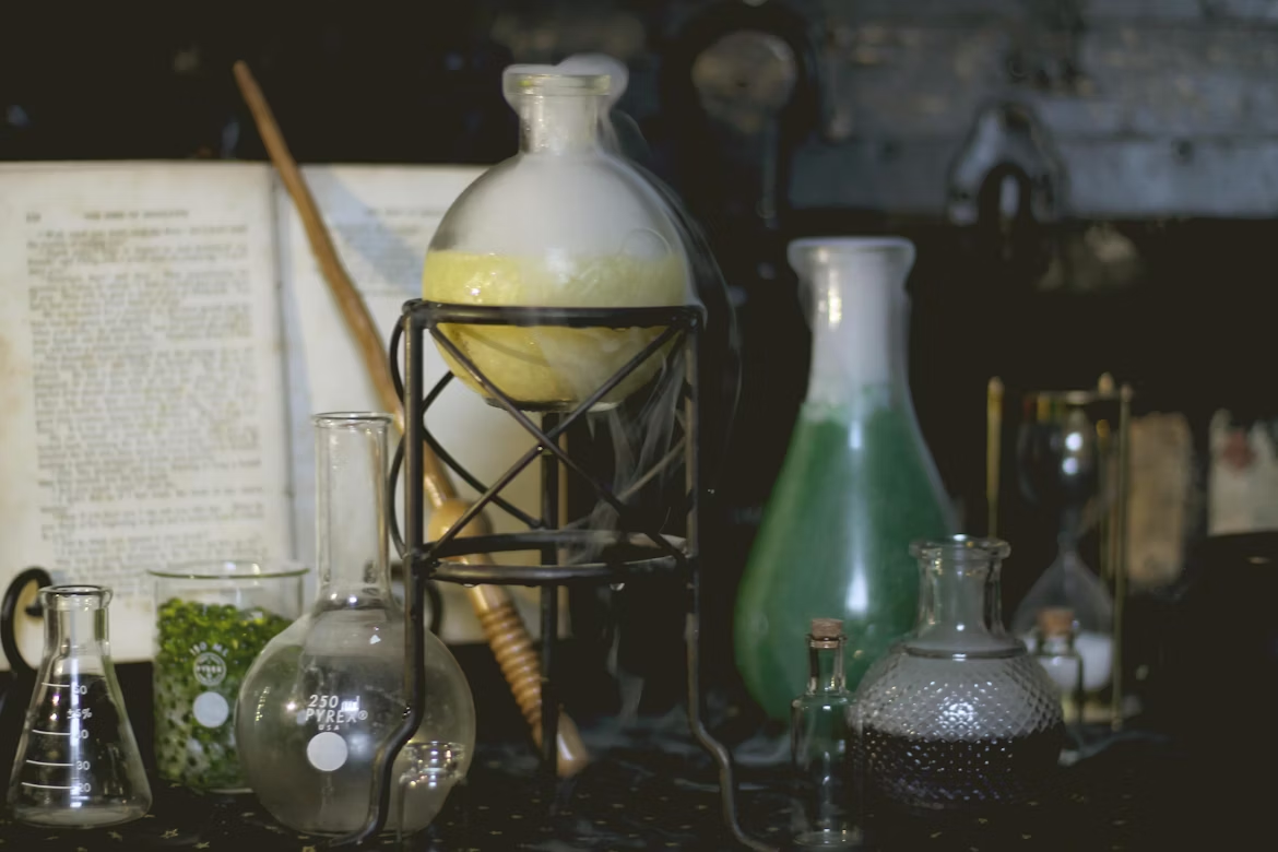 Vintage chemistry glassware with a steaming flask on a workbench, symbolizing accidental discoveries.