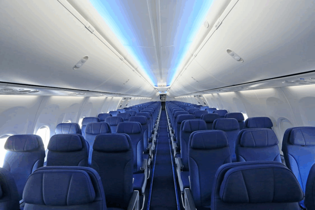 Airplane cabin interior with rows of blue seats, illustrating airplane seat color psychology.