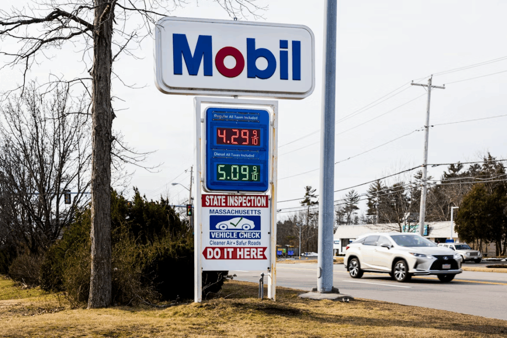 Mobil gas station sign in Massachusetts showing fuel prices ending in 9/10 of a cent.